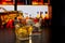 Barman pouring whiskey in front of whiskey glass and bottles