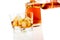 Barman pouring whiskey in the glasses in front of bottle on white background with reflection