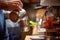 A barman is preparing a milk to make an espresso in the apparatus. Coffee, beverage, bar