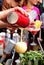 Barman\'s hand with shake mixer pouring cocktail into glass