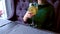 Barman serves a alcohol cocktail in wineglass to woman, puts it on the table. Hands close-up.