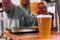 Barman serving cold beer at a street food market.