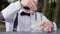 Barman stirring ice bar spoon on counter, glass with ice close-up, bartender makes cooling beverage to fresh air