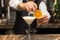 Barman at work, preparing cocktails. pouring pina colada to cocktail glass.