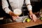 Barmans hands with coctail on the bar stand