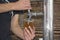 Barmen filling plastic glass with beer