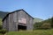 Barn with American flag on the side against a blue sky