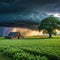 a barn in a field with a storm coming in the background and a tree in the foreground with a dark sky and clouds above with