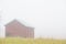 Barn in foggy autumn landscape