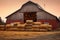 barn with hay bales stacked neatly inside