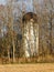 Barn silo from bygone era stands alone in woods