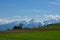 Barn on summer swiss green field and blue sky