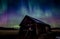 Barn under aurora borealis