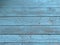 Barn wood wall with distressed, peeling blue paint