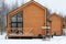 Barnhouse style house. The house is surrounded by snow. Winter and frost. Architectural style