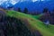 Barns on hill in mountainous landscape by dusk in winter