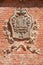 Barolo medieval castle coat of arms on red bricks wall in Italy