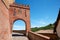 Barolo medieval castle entrance arch in red bricks in Italy