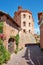 Barolo medieval castle and street with green plants in a sunny summer day
