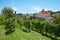 Barolo vineyards and medieval castle, blue sky in Italy