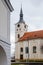 Baroque church of St. Mary Magdalene with clock tower at main Masaryk Square in city centre, spa resort in winter day, Lazne