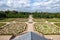 Baroque English landscape garden with white clouds and blue sky.