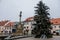 Baroque Marian column and Christmas tree at Square May 5th in Libochovice in winter day, Litomerice district, Bohemia, Czech