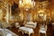 baroque room with many lavish furnishings, including gold and plush furniture