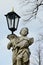 Baroque statue of angel holding street light, located on Calvary in Banska Stiavnica, Slovakia