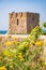 Baroque watchtower, beautiful old tower in San Vito, Polignano a Mare, Bari, Puglia, Italy with with blue sea