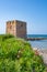 Baroque watchtower, beautiful old tower in San Vito, Polignano a Mare, Bari, Puglia, Italy with with blue sea