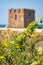 Baroque watchtower, beautiful old tower in San Vito, Polignano a Mare, Bari, Puglia, Italy with with blue sea