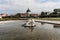 baroque white cascade fountain with water splashes with patterns. Beautiful fountain with antique sculptures in the park