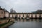 Barrage Vauban surrounded by water and buildings under a cloudy sky in Strasbourg in France