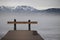 Barred wooden nose-piece on frozen lake in Upper Bavaria with Alps in background in winter with snow