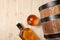 Barrel, bottle and glass of tasty whiskey on wooden table, flat lay. Space for text