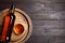 Barrel, bottle and glass of tasty whiskey on wooden table, top view. Space for text