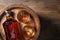 Barrel, bottle and glasses of tasty whiskey on wooden table, top view. Space for text