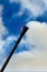 Barrel of a machine gun in a diagonal frame against a blue sky