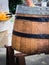 Barrel restoration, a man painting an old wine barrel. Half barrel for plants