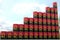 Barrels with flag of Angola form rising chart or upwards trend. Oil industry success concept, 3D rendering