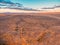 Barren desert land and hills in the distance.