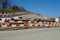 Barrier planks of red and white colors serving as a fence on a large civil engineering building place.