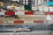 Barrier planks of red and white serving as a fence on a large civil engineering building place.