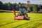 Barron County, WI / USA  - August 29 / 2020: White tractor attached to a New Holland chopper on a freshly chopped hay field during