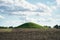 Barrow in fields, blue cloudy sky, Mon Island, Denmark, Europe