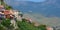 Bars and restaurants of the village of Molyvos clinging to the hillside with backdrop of mountains.