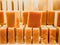 Bars of soap on a shop window. Orange soap with natural cedar oil and herbal ingredients. Handmade natural cold process soap. Eco-