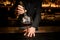 Bartender adding big ice cube in a cocktail