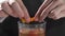 Bartender adds orange peel to the alcohol drink at the bar, making of the cocktails in the bar, alcohol drinks, alcohol